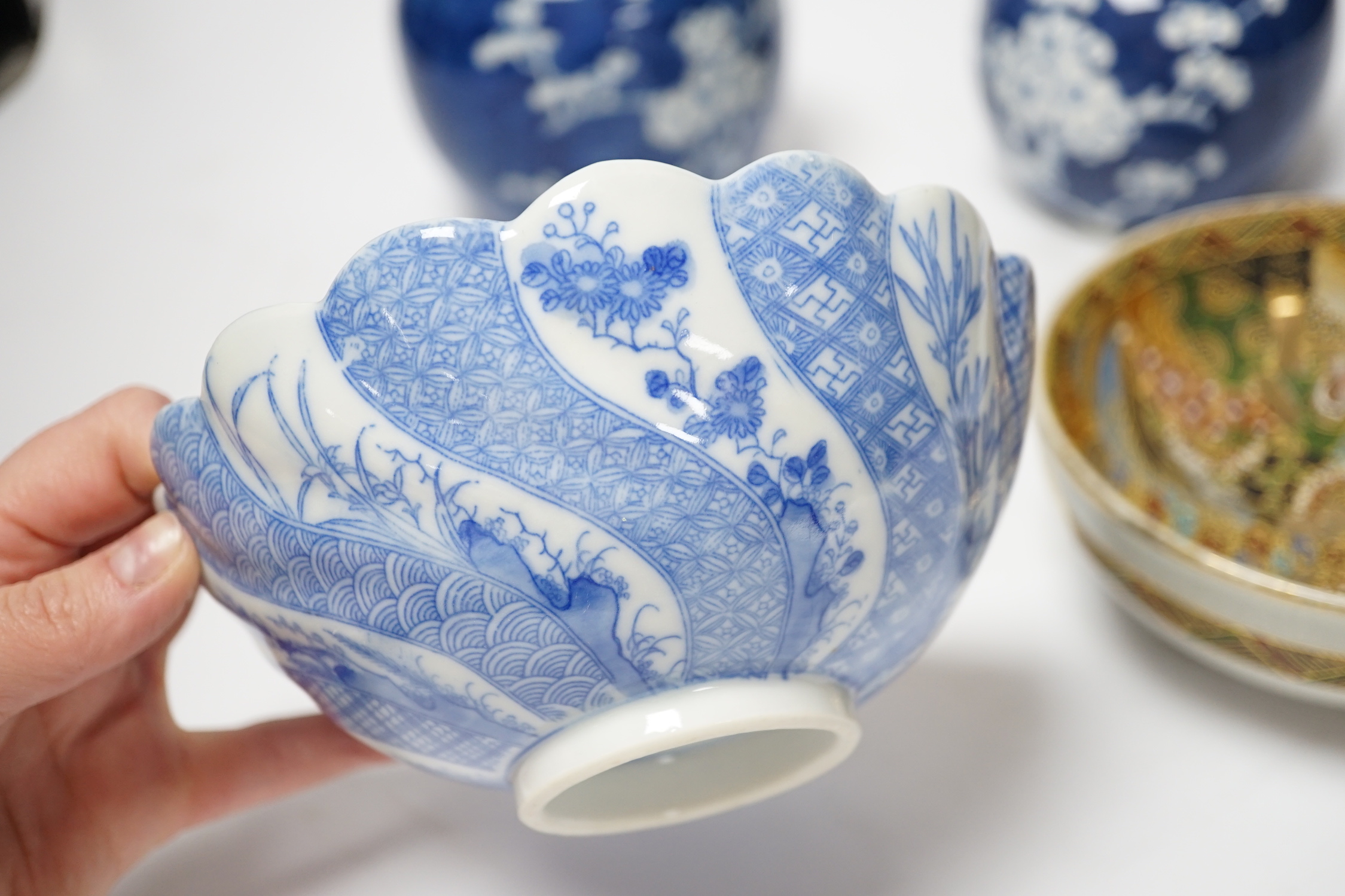 A collection of seven Chinese Prunus blossom jars, three with covers and two bowls